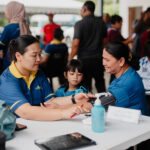 UNIMAS staff conduct free health screenings for a Kampung Tringgus Bau resident as part of the KPT Prihatin Madani Siri 23 programme.